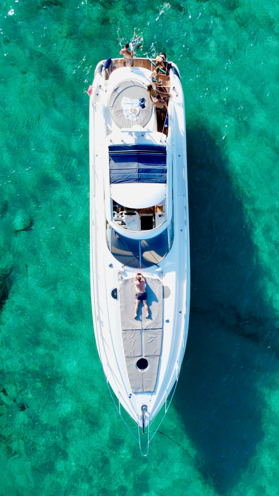 a white boat floating on top of a body of water